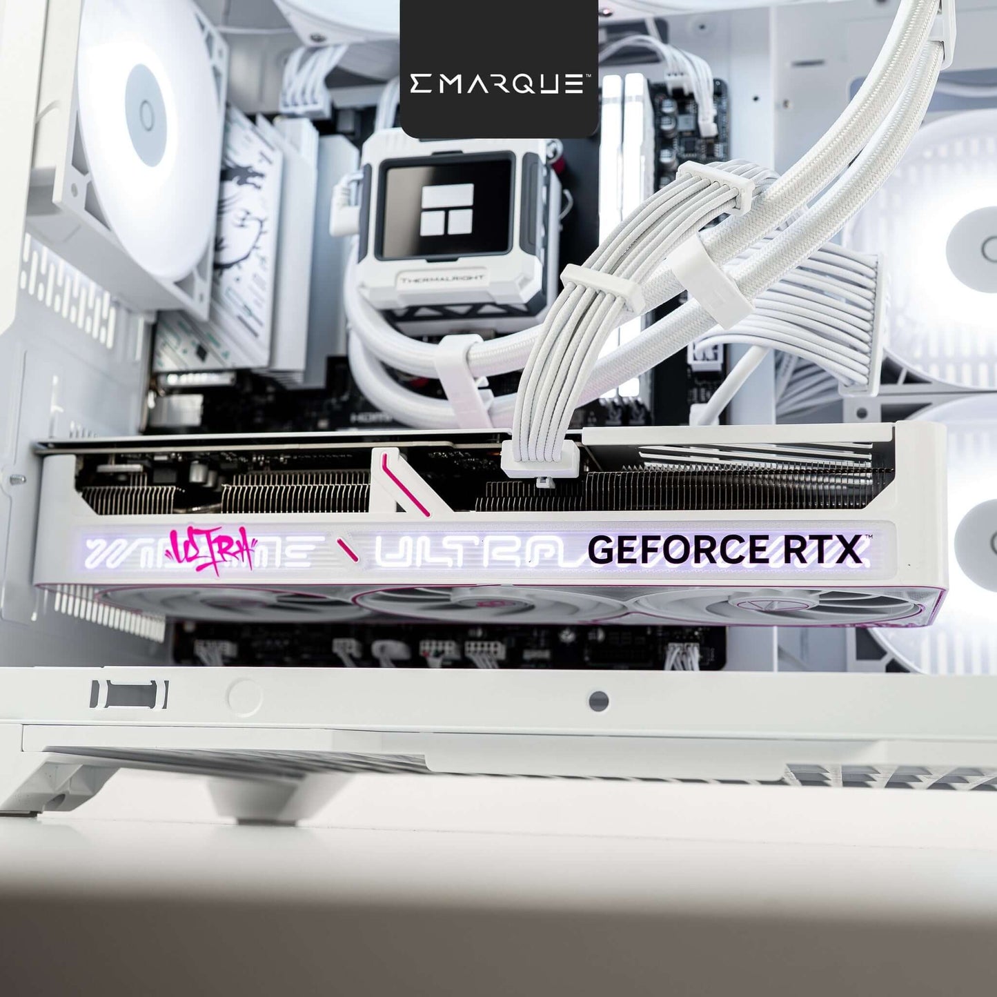 Close-up view of GeForce RTX graphics card in a white gaming PC build with RGB lighting and cable management.
