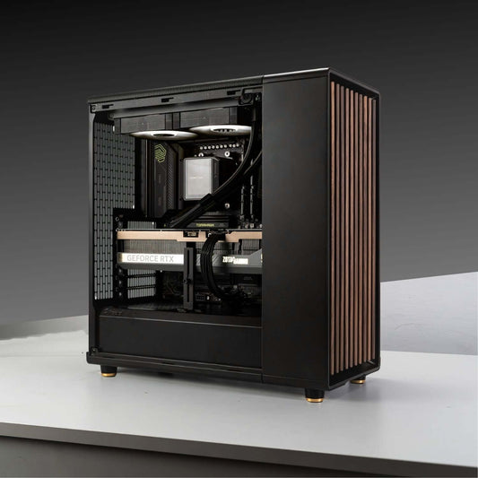 Gaming PC build with AMD Ryzen 7 9800X3D, GeForce RTX 5070 Ti in Fractal Design North Charcoal Black case on gray background.
