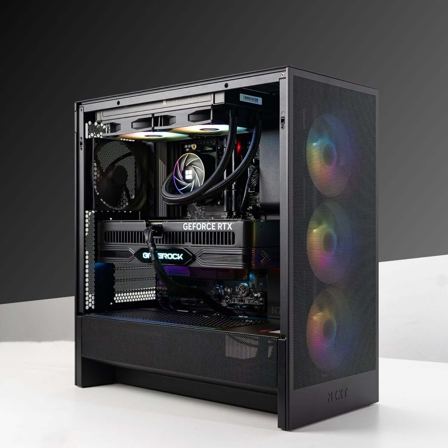 Gaming PC with AMD Ryzen 7 9800X3D and NVIDIA GeForce RTX 5090 showcasing RGB lighting and advanced cooling setup.