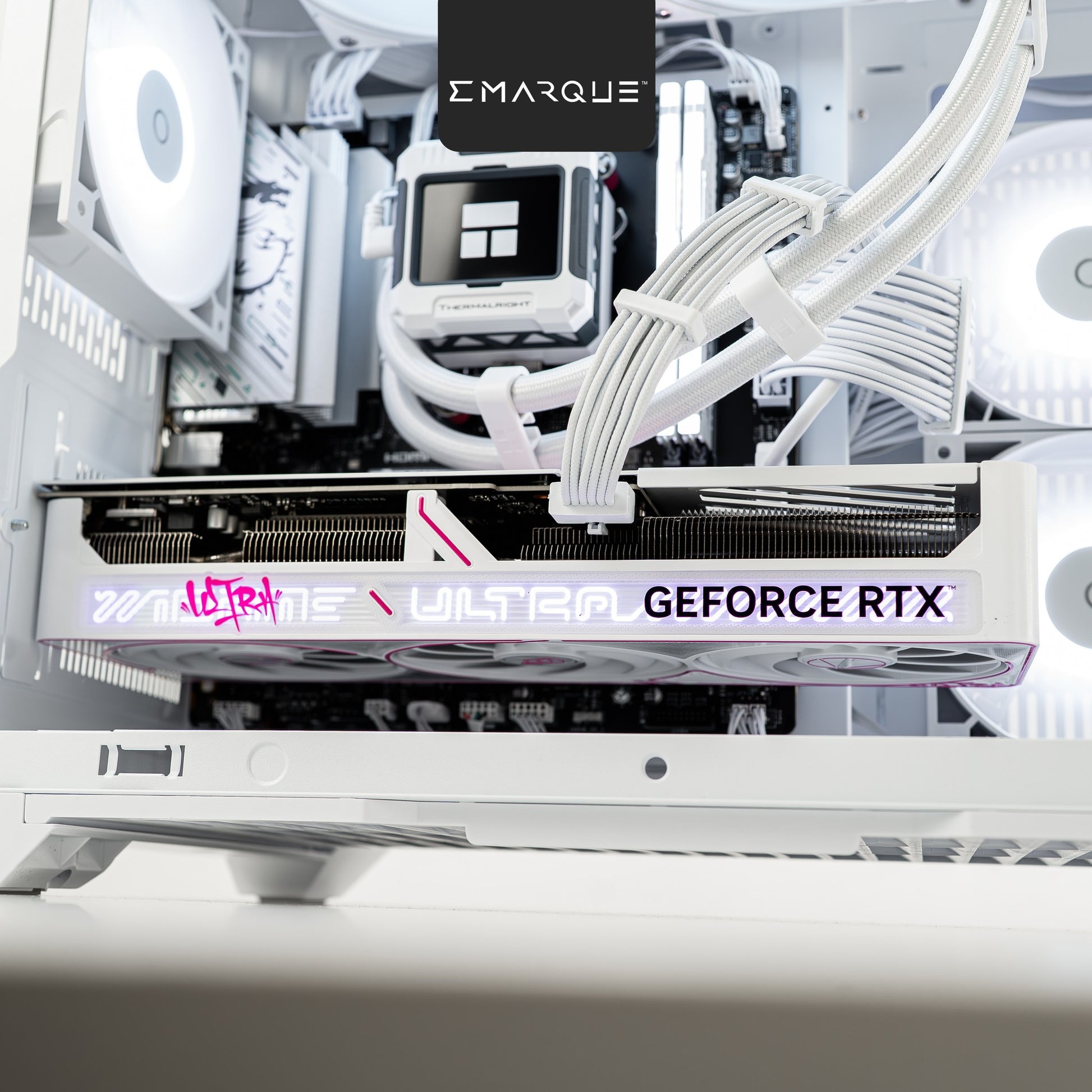 Close-up view of GeForce RTX graphics card in a white gaming PC build with RGB lighting and cable management.