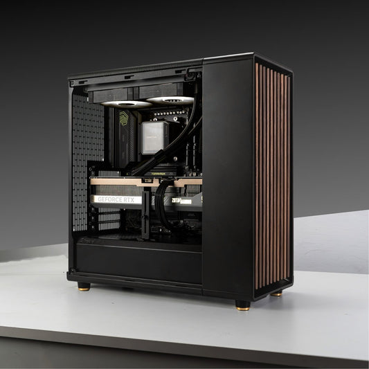 Gaming PC build with AMD Ryzen 7 9800X3D, GeForce RTX 5070 Ti in Fractal Design North Charcoal Black case on gray background.