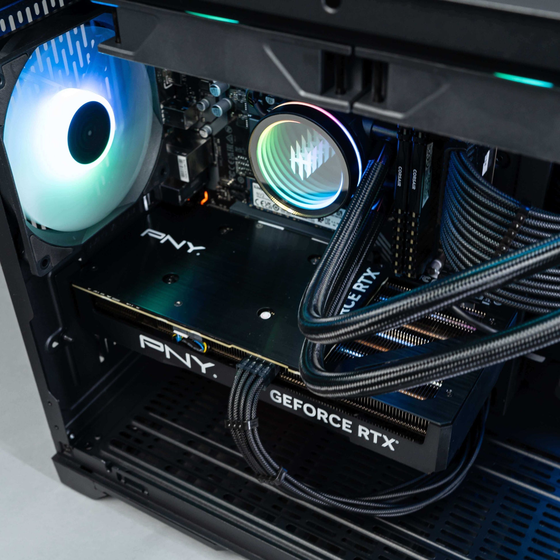 Interior view of a gaming PC featuring a PNY GeForce RTX graphics card and RGB lighting.