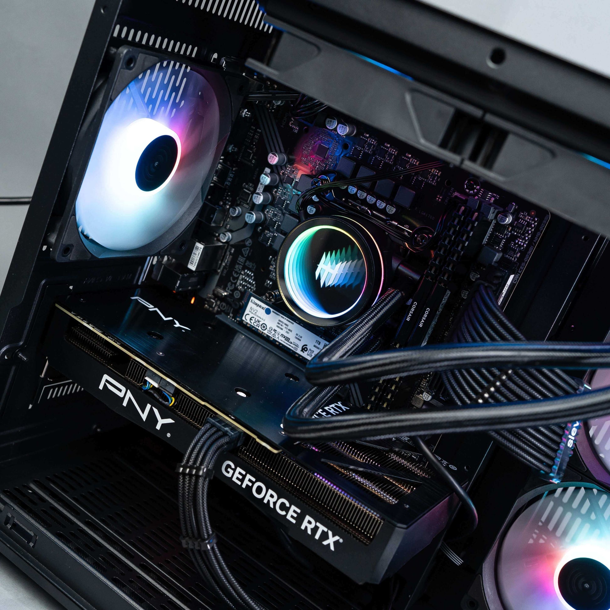 High-performance gaming PC with PNY GeForce RTX GPU and RGB lighting, showcasing advanced cooling and interior design.
