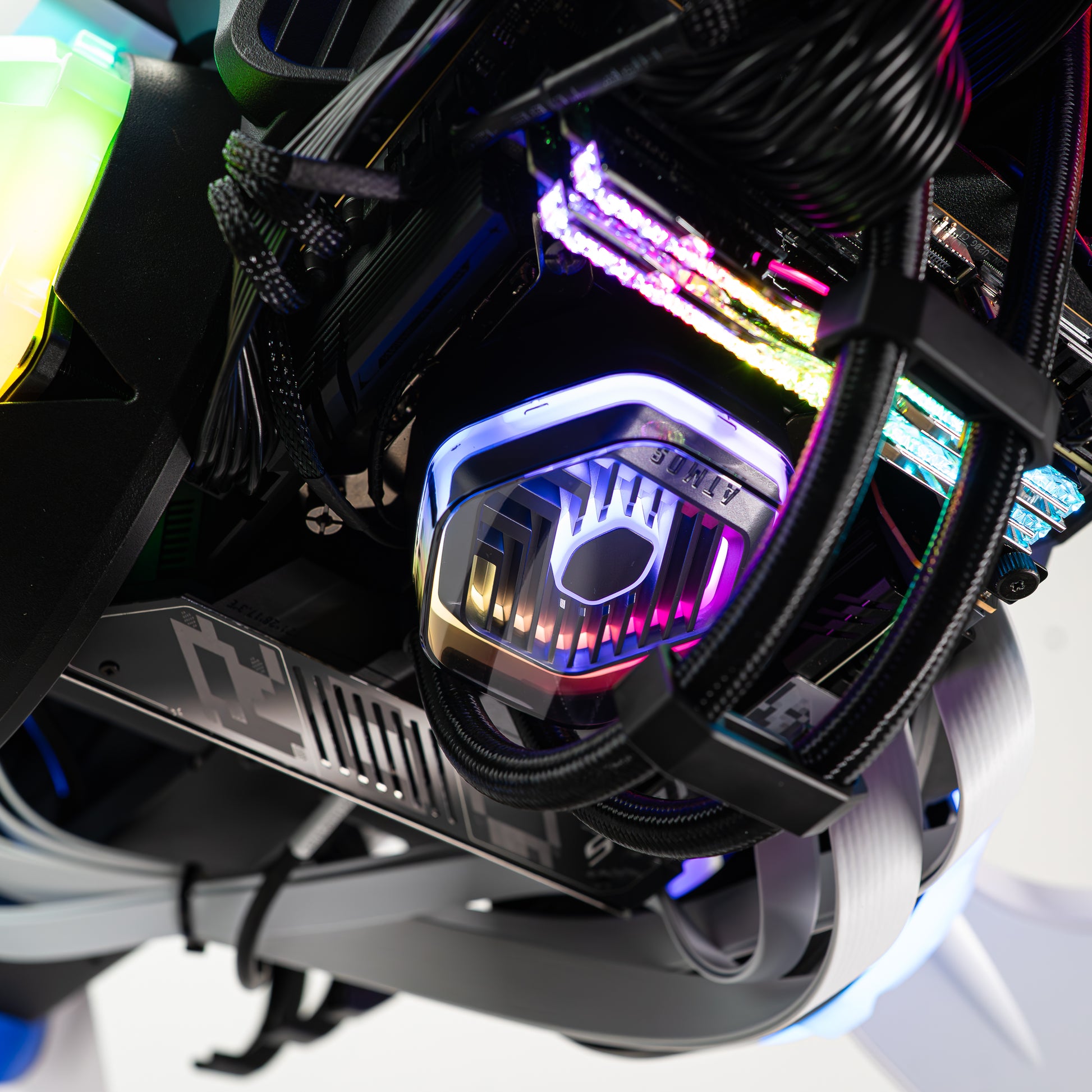 Close-up of APEX Shark X PC with Intel Core Ultra 9 and GeForce RTX 5080, showcasing vibrant RGB lighting and sleek design.