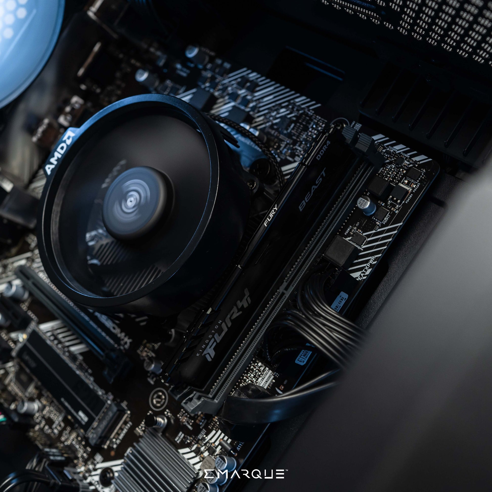 Close-up of EMARQUE NEO Gaming PC internals featuring AMD Ryzen 7 8700G processor and Radeon 780M graphics card.