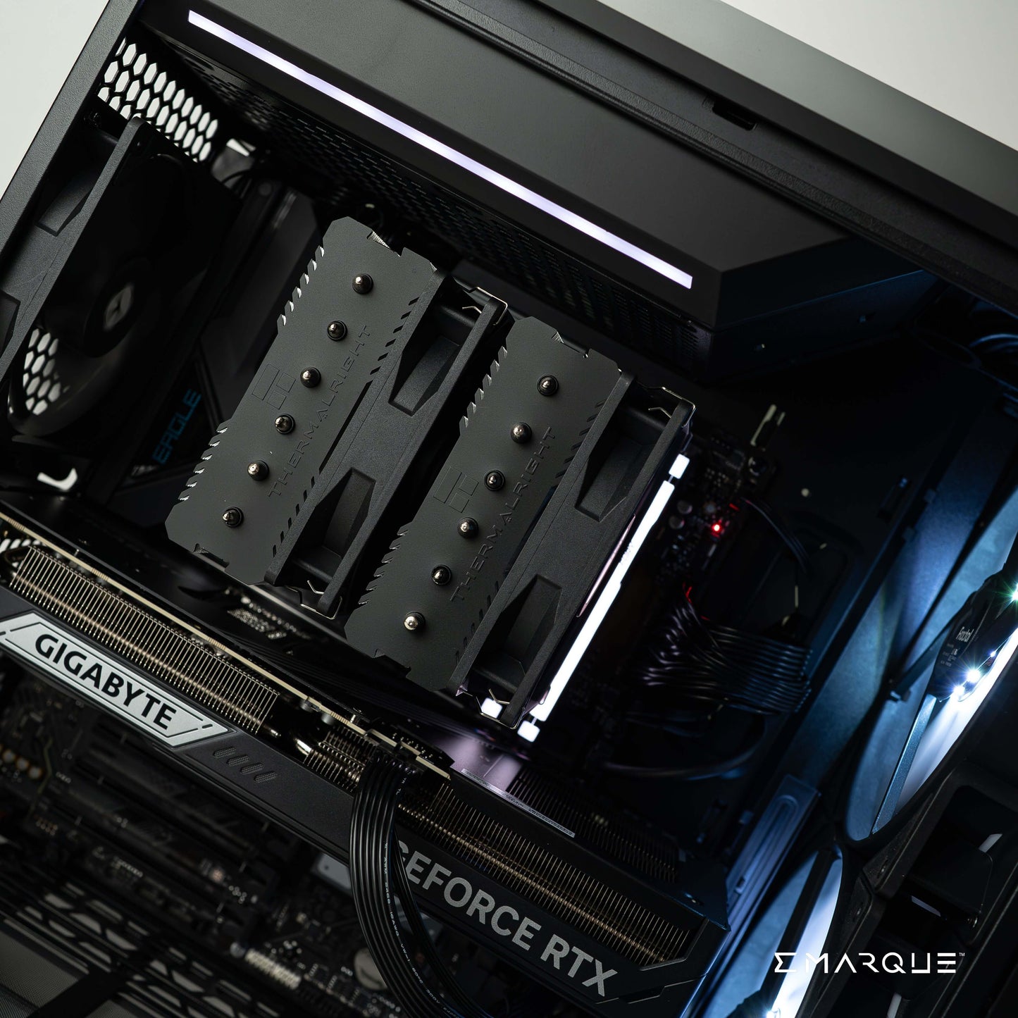 High-performance gaming PC interior featuring AMD Ryzen 7 9800X3D, GeForce RTX 5080, and RGB lighting setup for ultimate gaming experience.