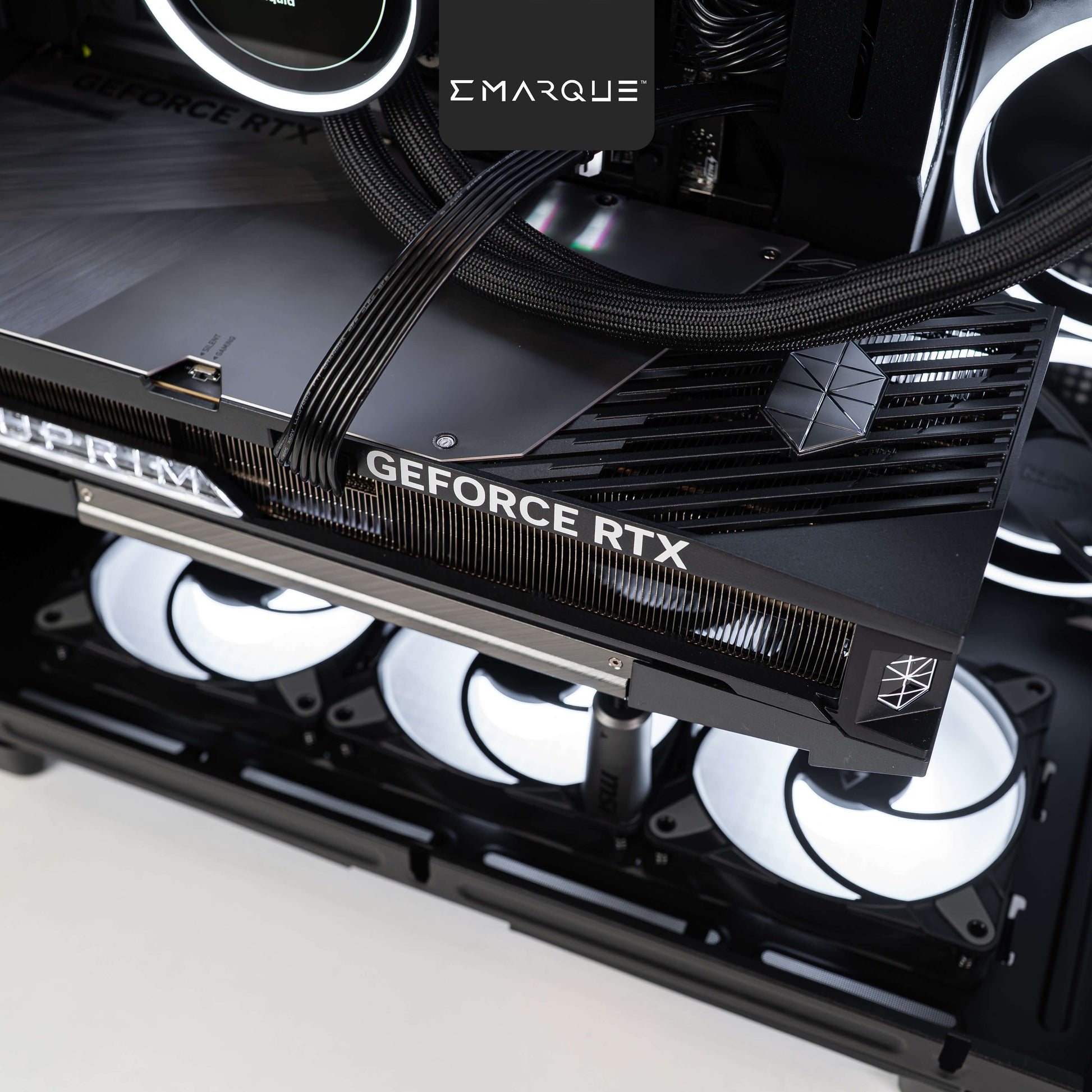 Close-up of a GeForce RTX graphics card installed in a high-performance gaming PC with RGB cooling fans.